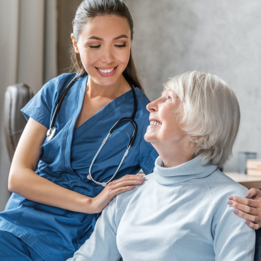 vertical-portrait-of-happy-elderly-woman-with-nurse-at-home (1)