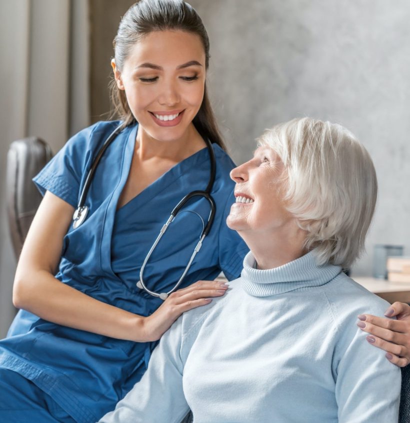 vertical-portrait-of-happy-elderly-woman-with-nurse-at-home