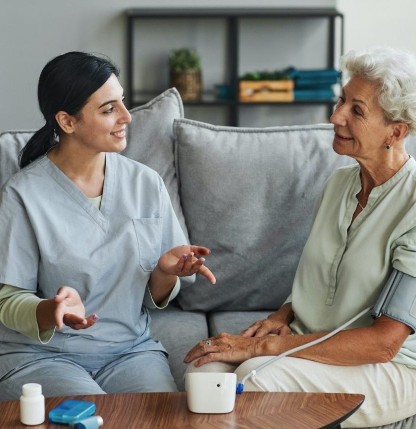 young-nurse-talking-to-senior-woman-in-retirement-home
